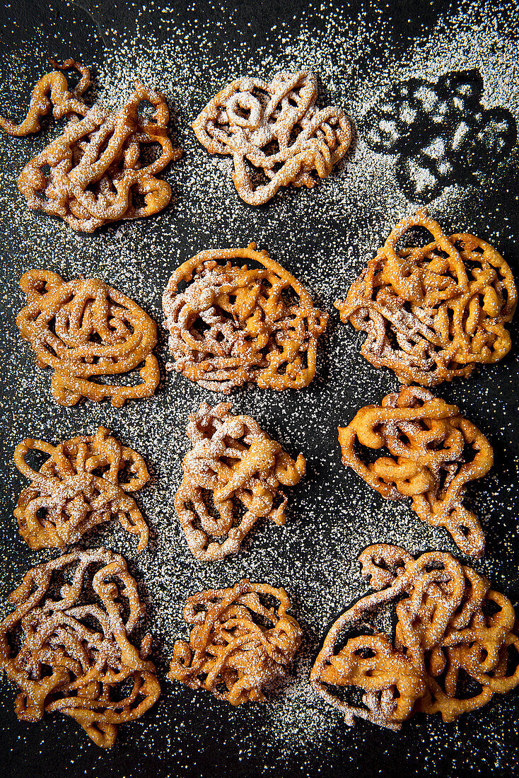 Funnel cakes with icing sugar, view from above