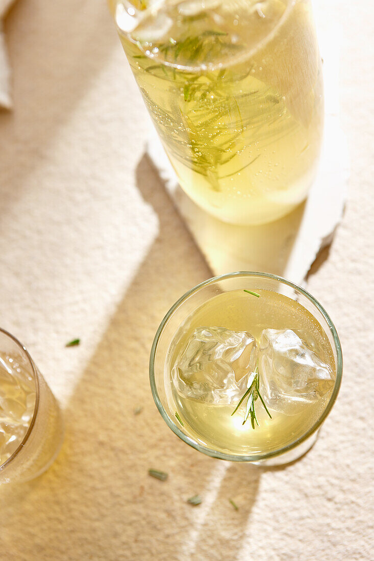 Limoncello with rosemary and ice cubes
