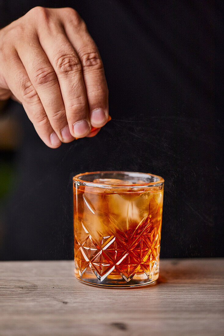 Making Old Fashioned cocktail