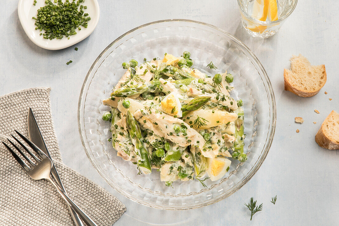 Chicken salad with eggs, asparagus, peas and capers