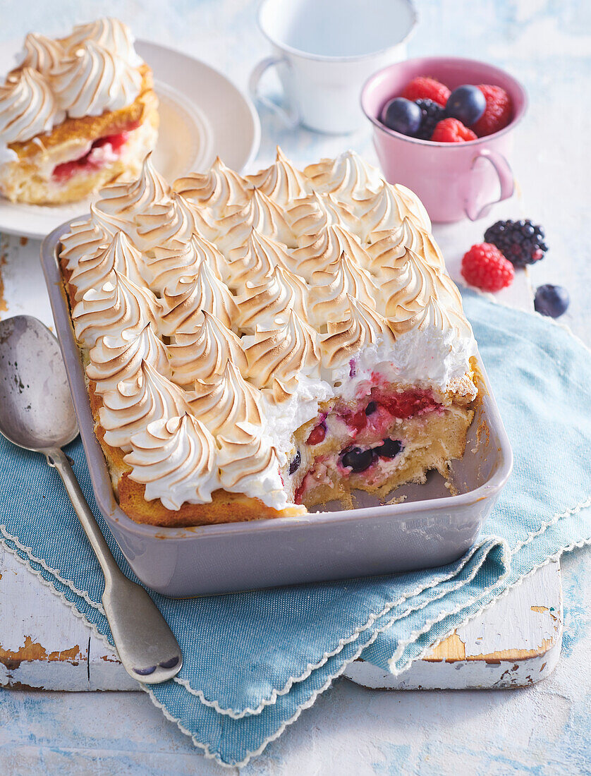 Baked bread pudding with berries and meringue