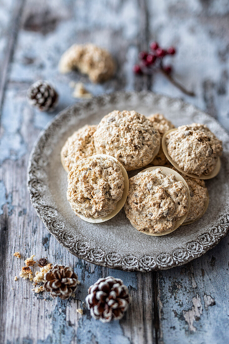 Macarons with oat flakes and chocolate drops on wafers for Christmas