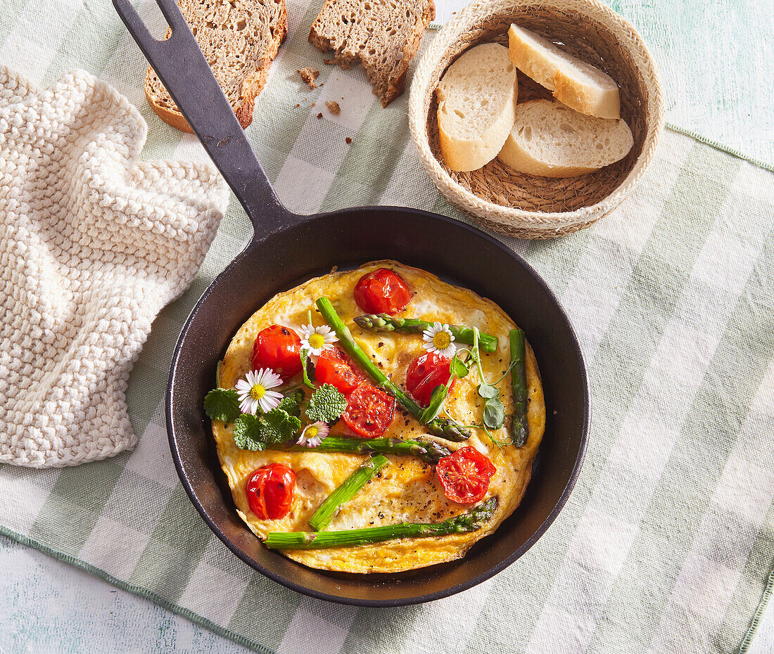 Omelette with green asparagus and cherry tomatoes