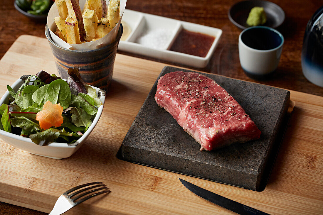 Raw Wagyu beef on hot lava stone