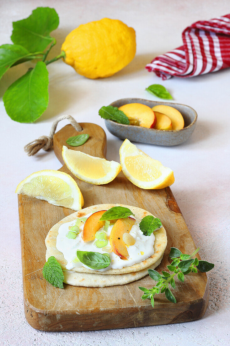 Piadina with stracciatella, peaches and spring onions