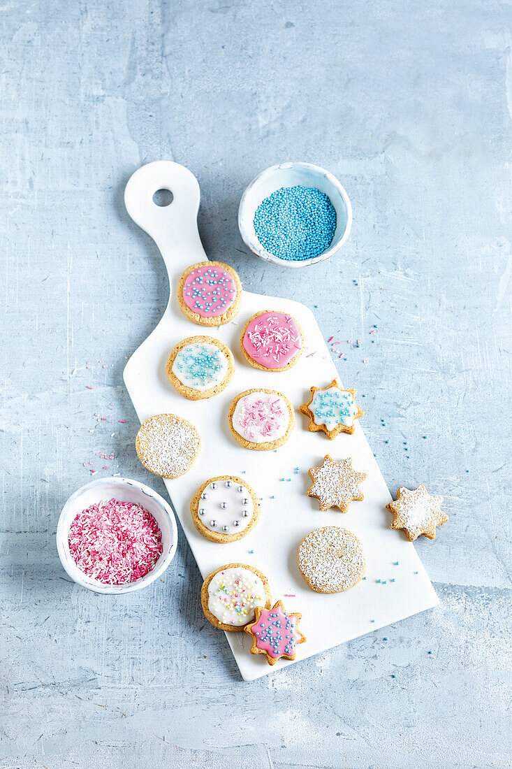 Children's biscuits decorated with icing and colored sugar pearls