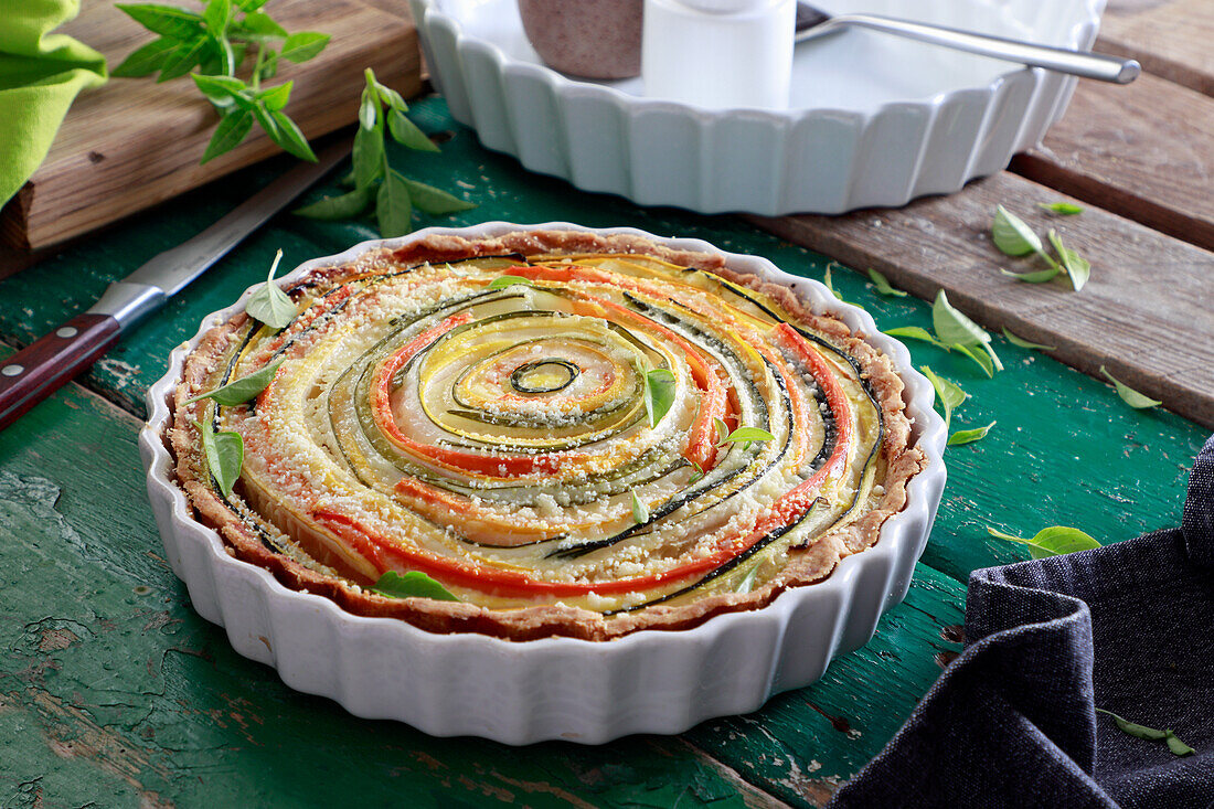 Tart with spirally twisted strips of zucchini and carrots