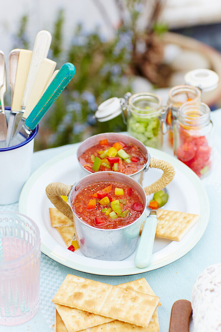 Gazpacho in metal cups on a terrace table