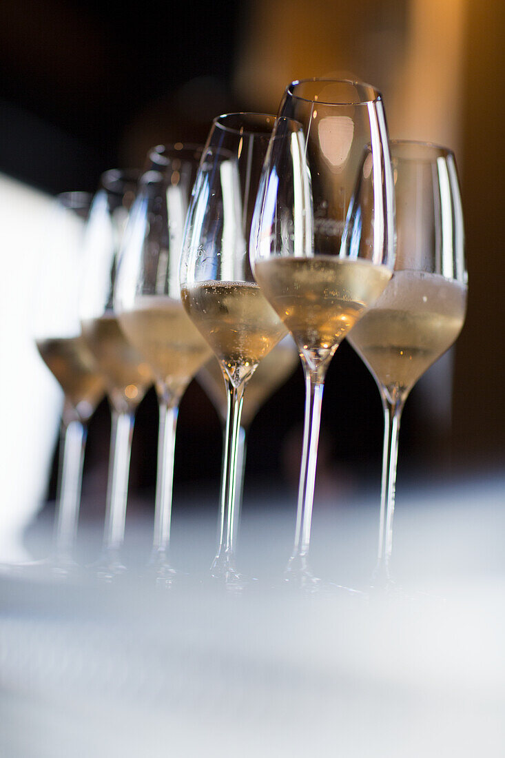 Glasses with champagne on yellow background