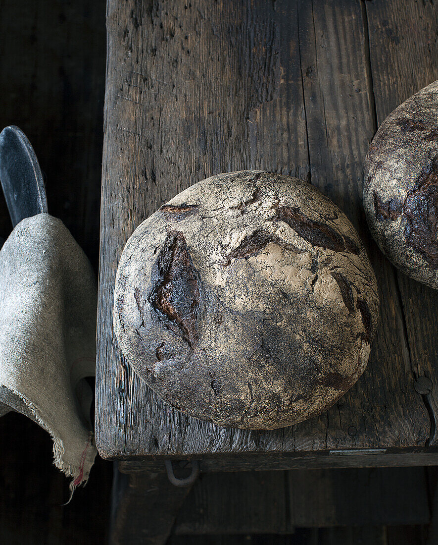 A rustic rye-blend loaf on a wooden table