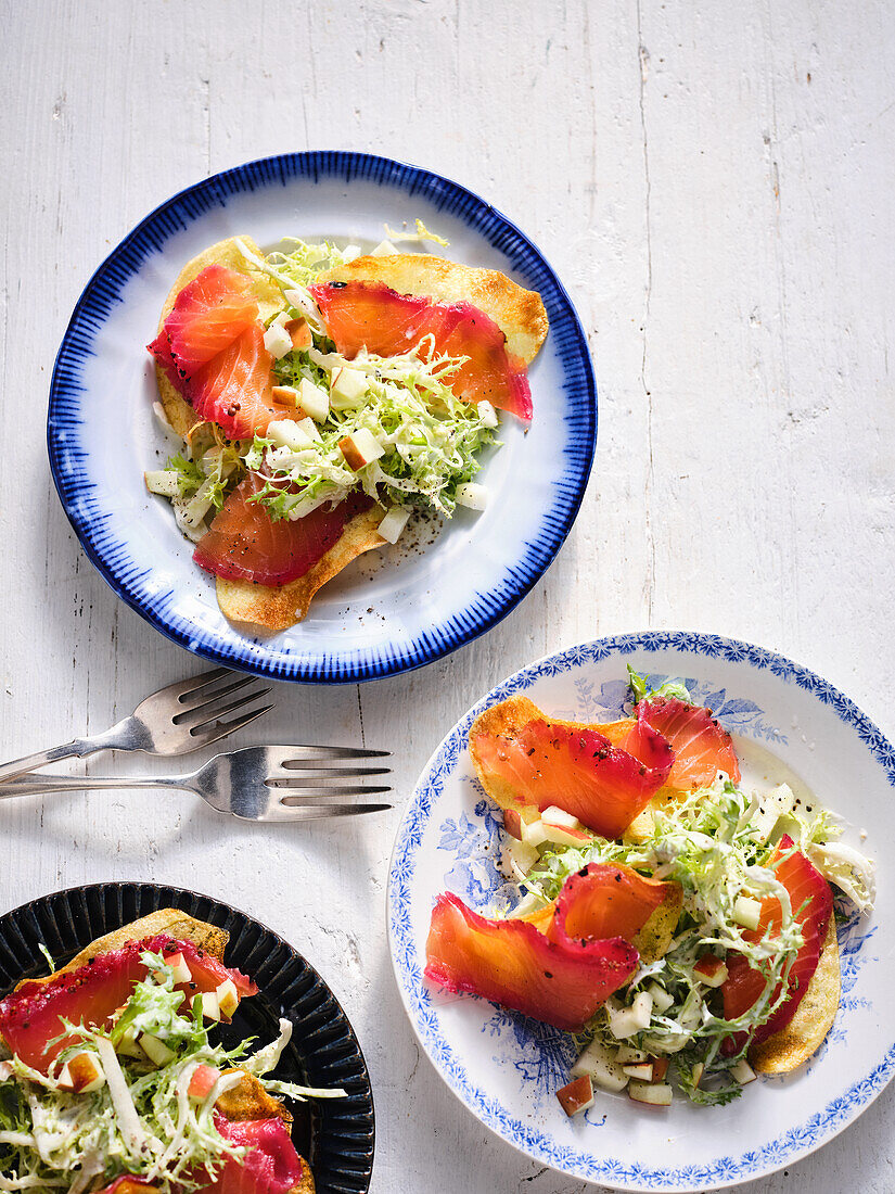 Mainated beetroot salmon with fried potatoes and frisee lettuce-and-apple salad