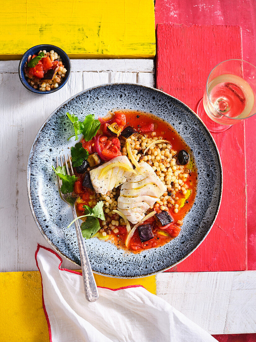 Poached cod with fregola and tomato sauce