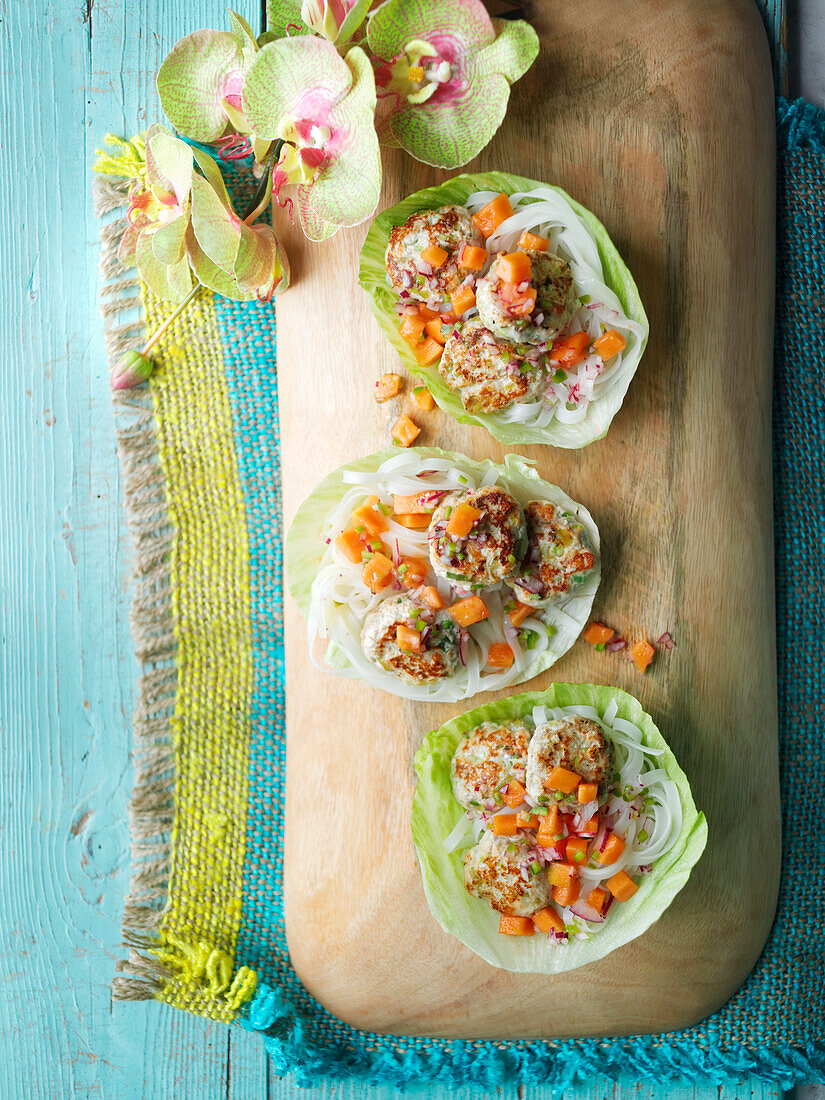 Tamarinden-Hähnchen-Patties mit Papaya-Salsa im Salatblatt serviert