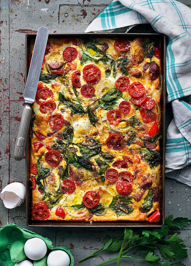 Frittata with eggs, spinach, tomatoes, onions and parsley