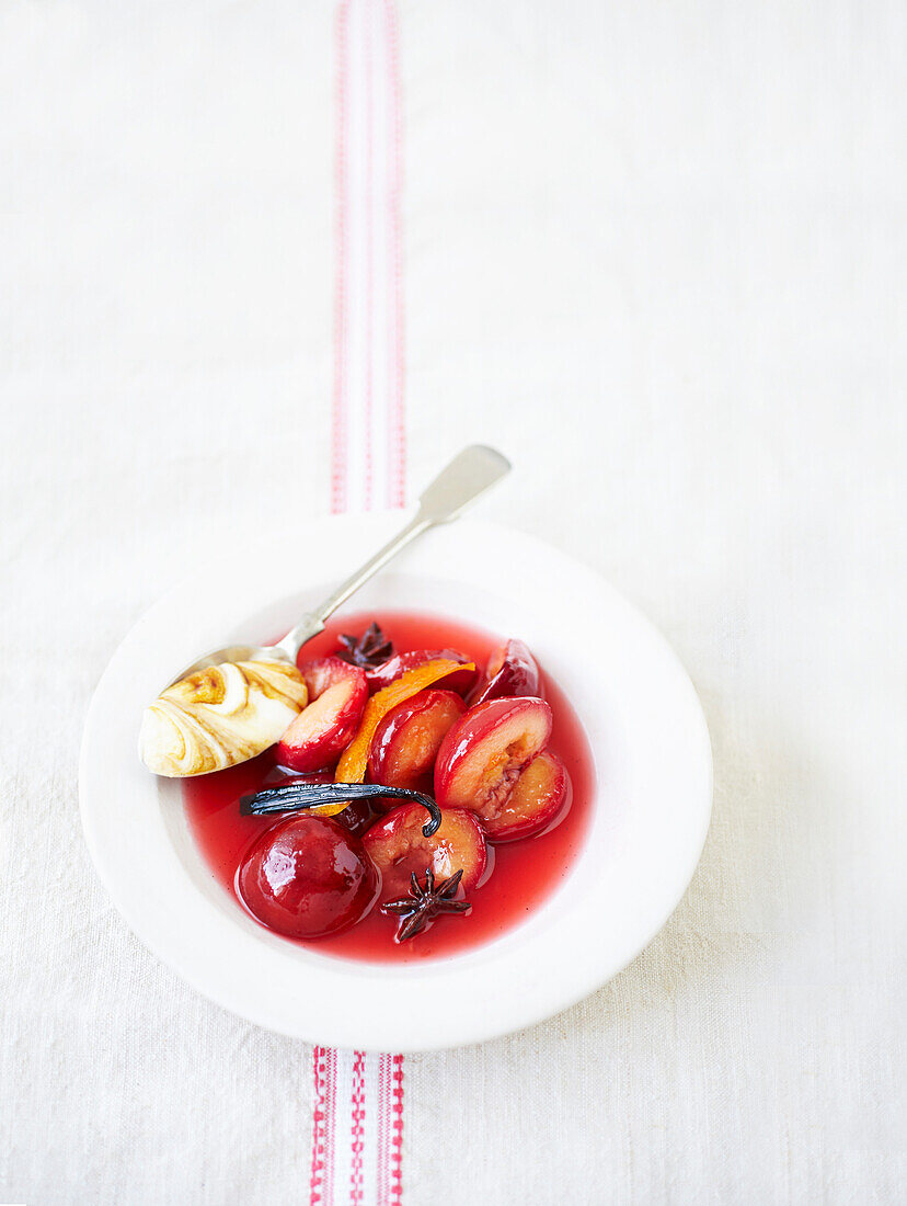 Poached plums in spiced rum syrup
