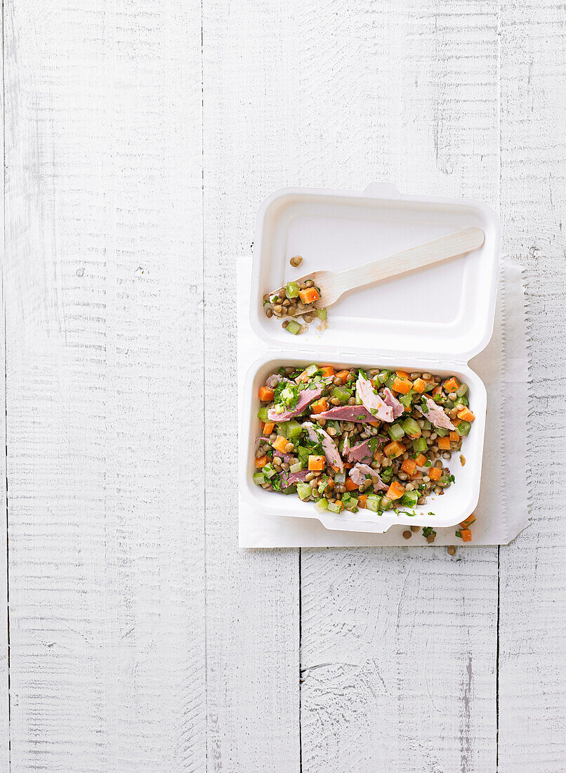 Lentil and carrot salad with ham in a to-go box