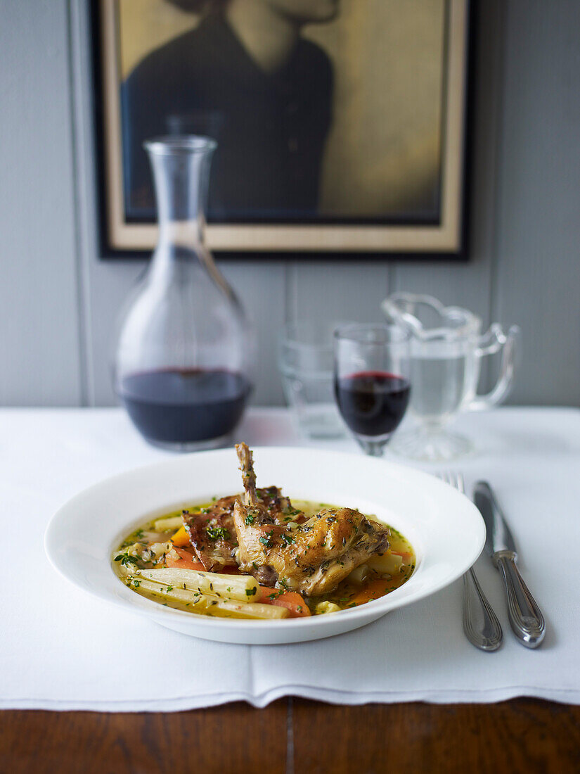 Braised rabbit with salsify and cider on a restaurant table