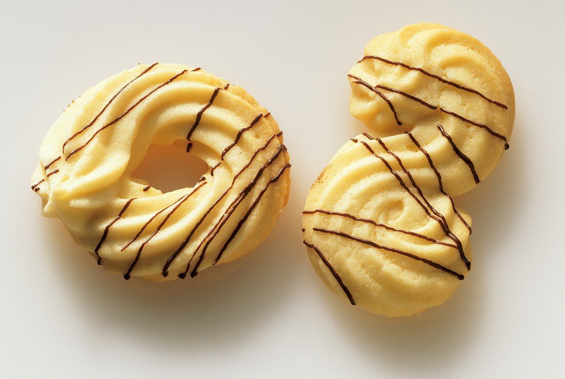 Piped biscuits, one ring-shaped, one 'S'-shaped