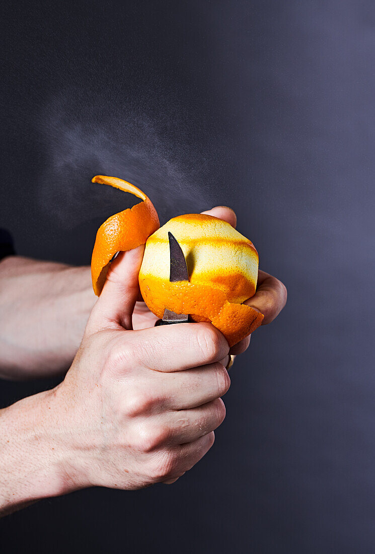 Peeling an orange with a knife