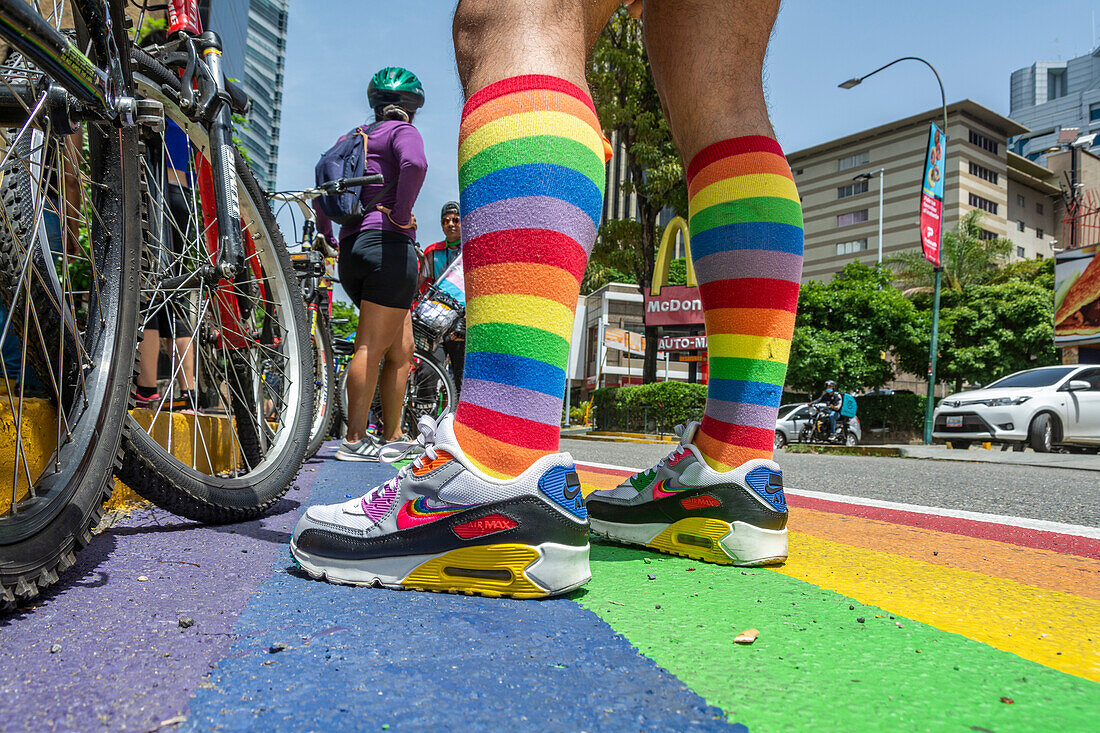 Cyclists riding on rainbow flag bike lane