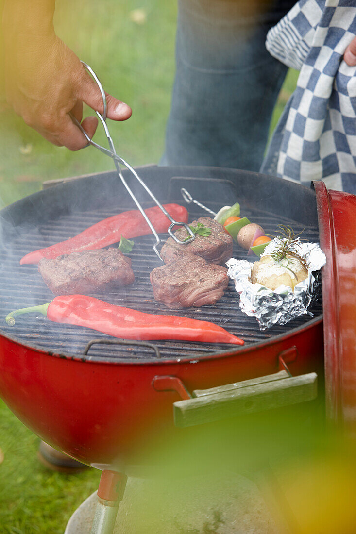 Grill with steaks and vegetables