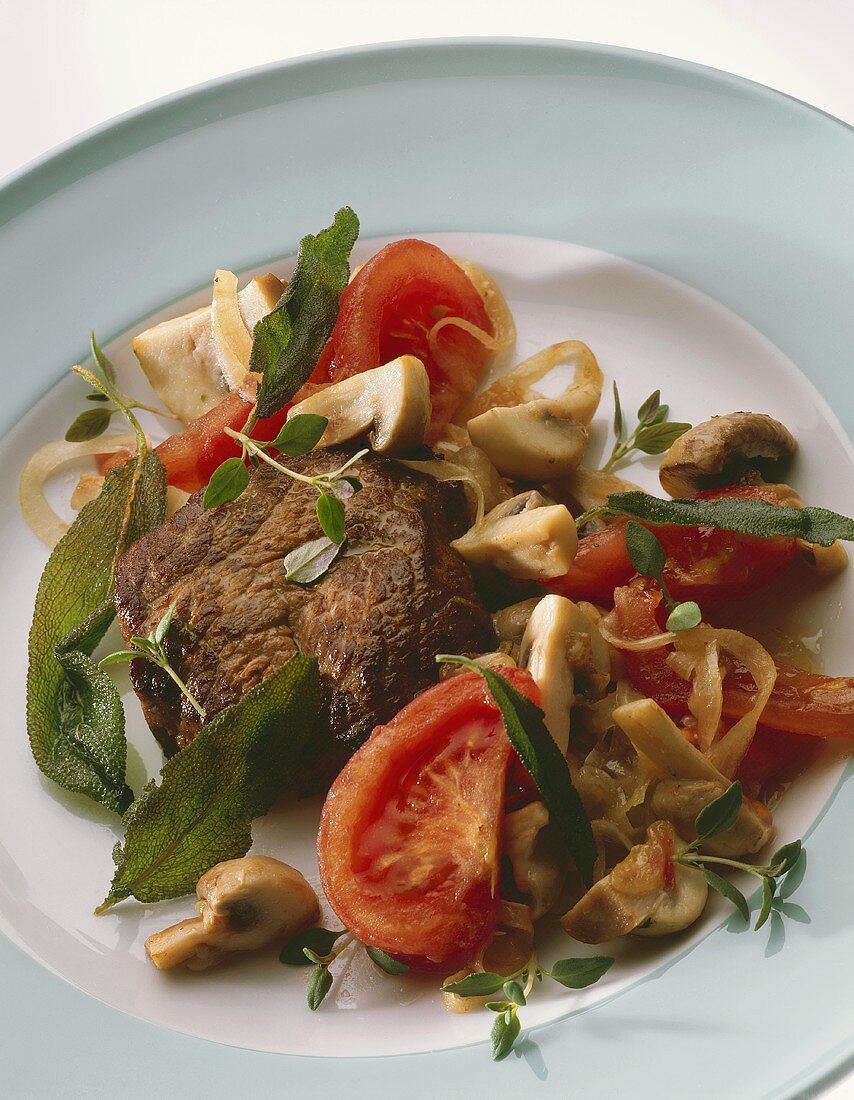 Marinated beef steak with mushrooms, tomatoes & herbs