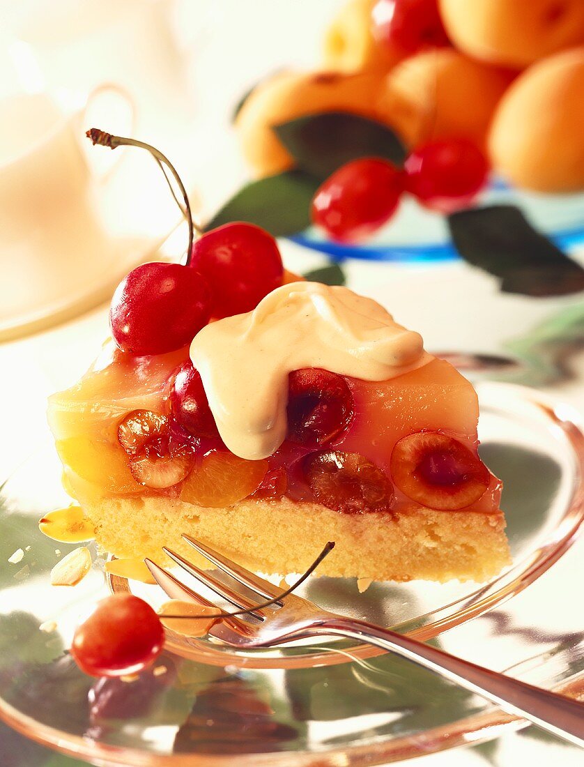 A piece of fruit gateau with apricots & cherries