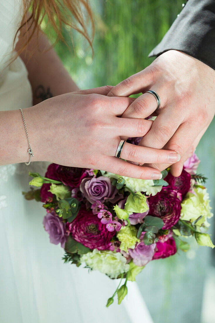 Bridal bouquet, hands with rings
