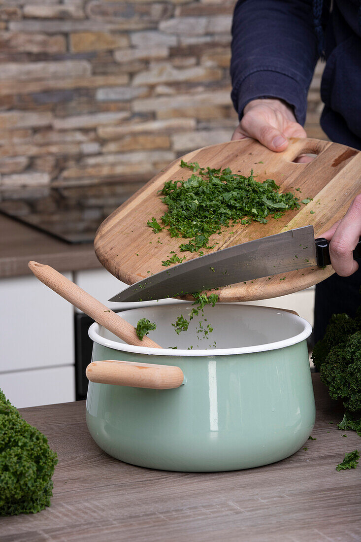 Stuffing kale into pot