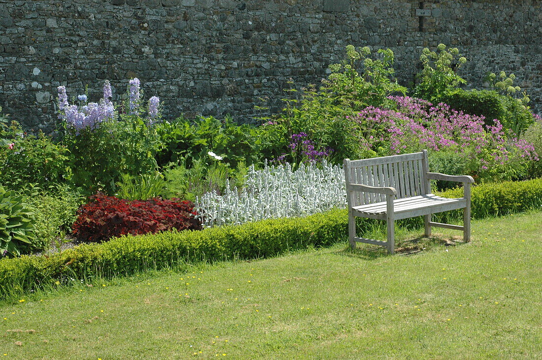 Bench in front of shrub bed