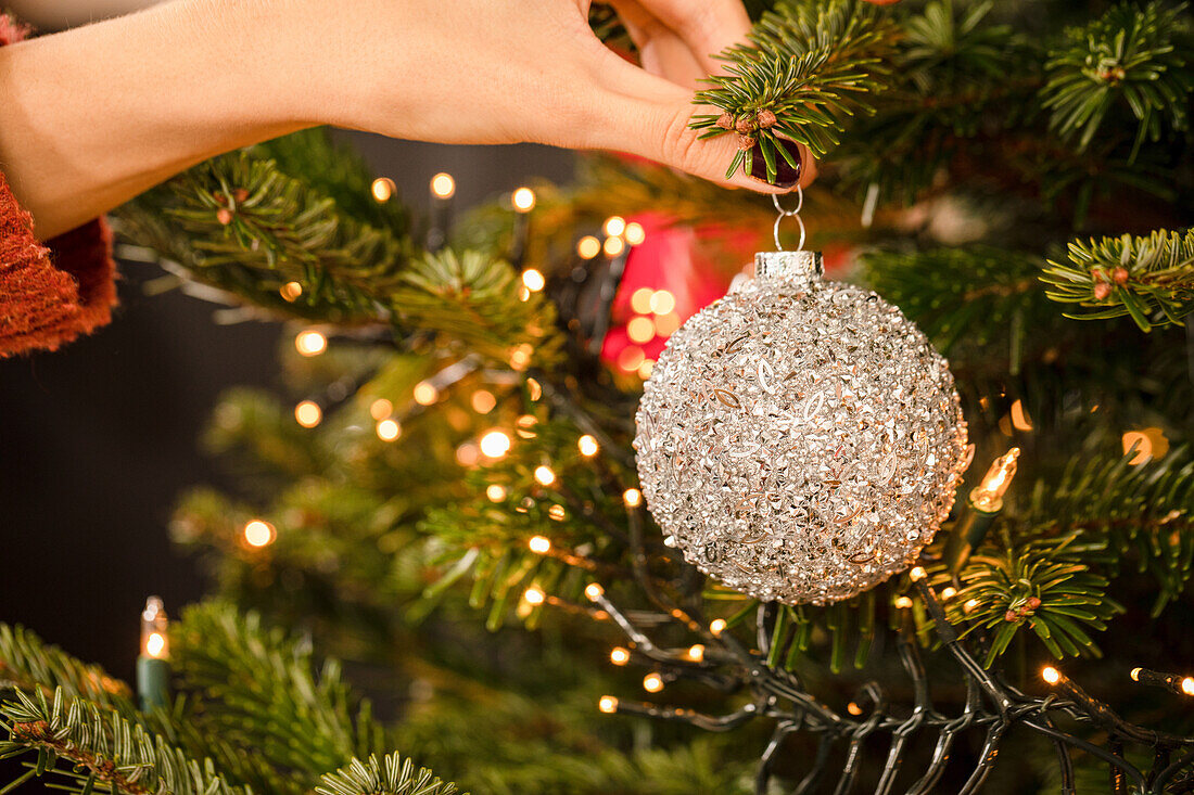 Hanging up the Christmas tree ball