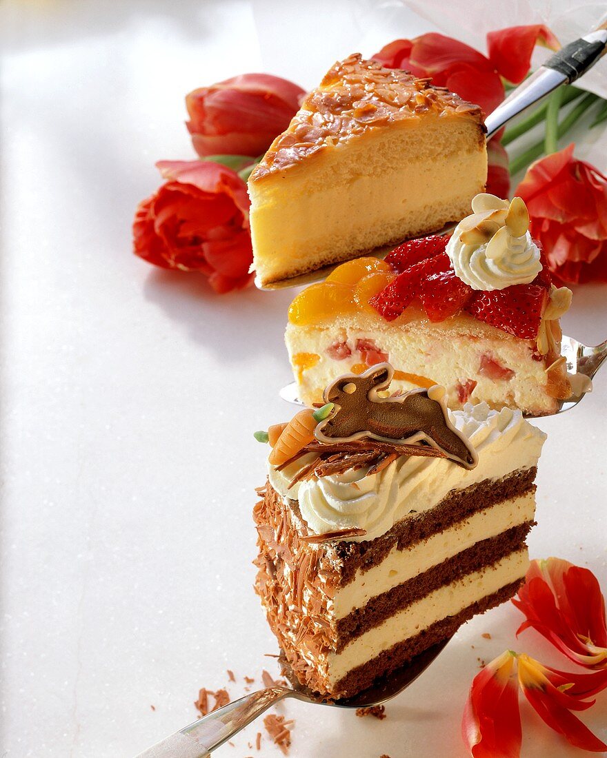 Three different pieces of gateau on cake slices