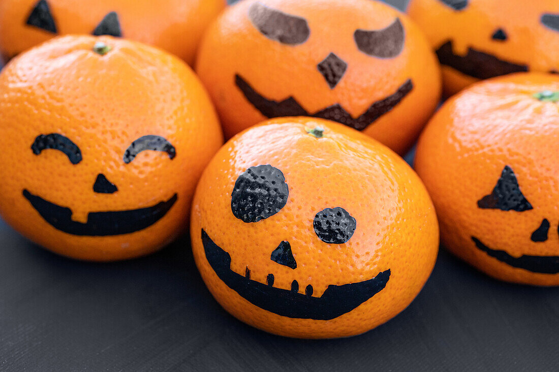 Pumpkin faces on mandarins