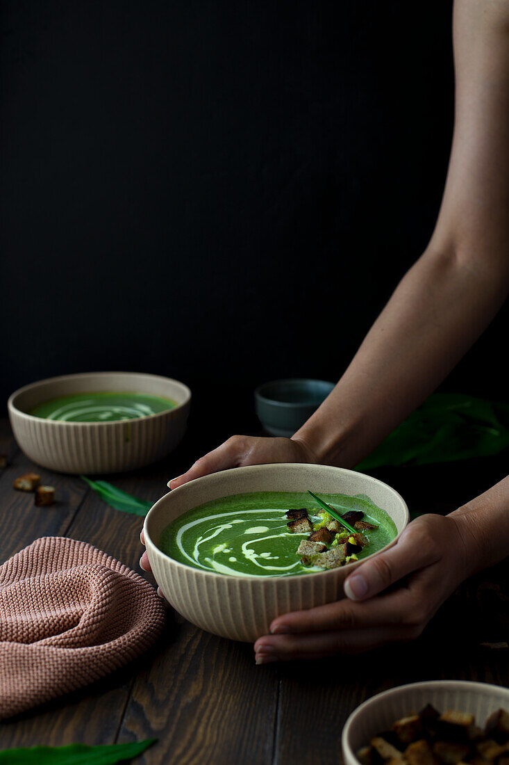 Vegan wild garlic soup with coconut milk and croutons