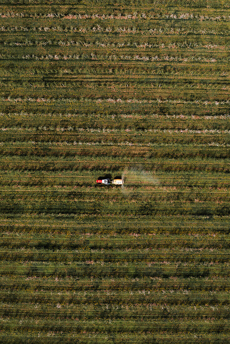 Aerial view of agricultural tractor with crop sprayer