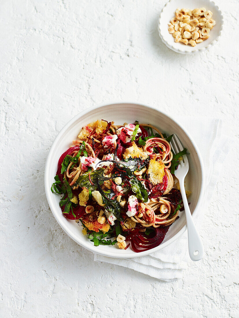 Beetroot spaghetti with hazelnut and goat's cheese