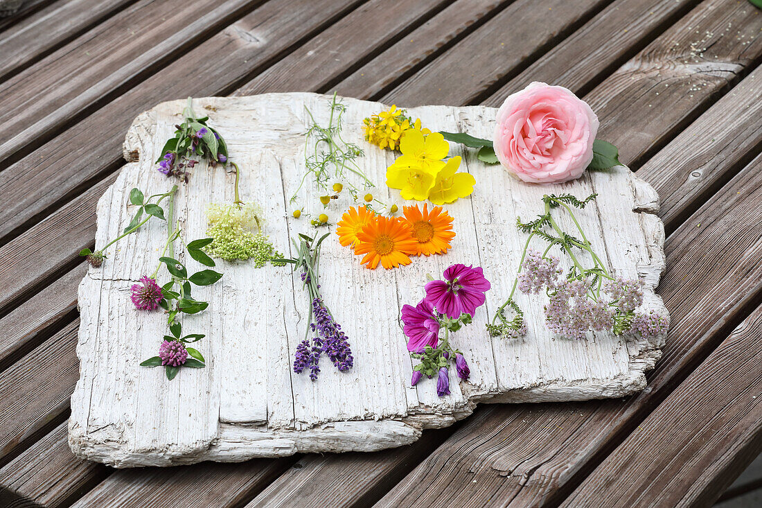 Various flowers on a white stone slab