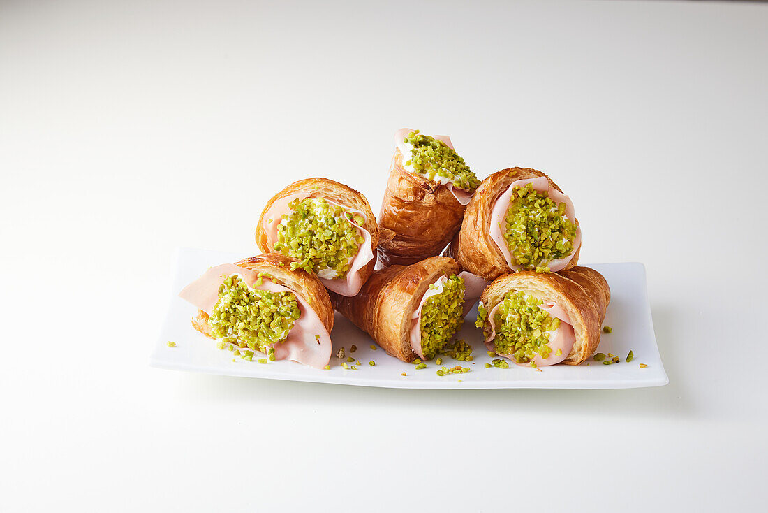 Croissants filled with mortadella, goat's cheese and pistachios