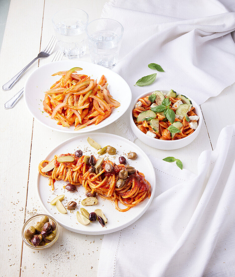 Three dishes with tomato sauce