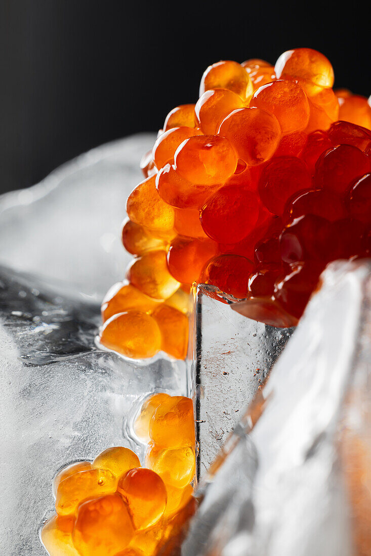 Red caviar on blocks of ice (close-up)
