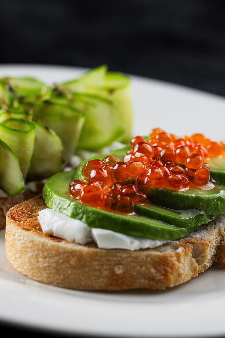 Bread with cream cheese, avocado and caviar