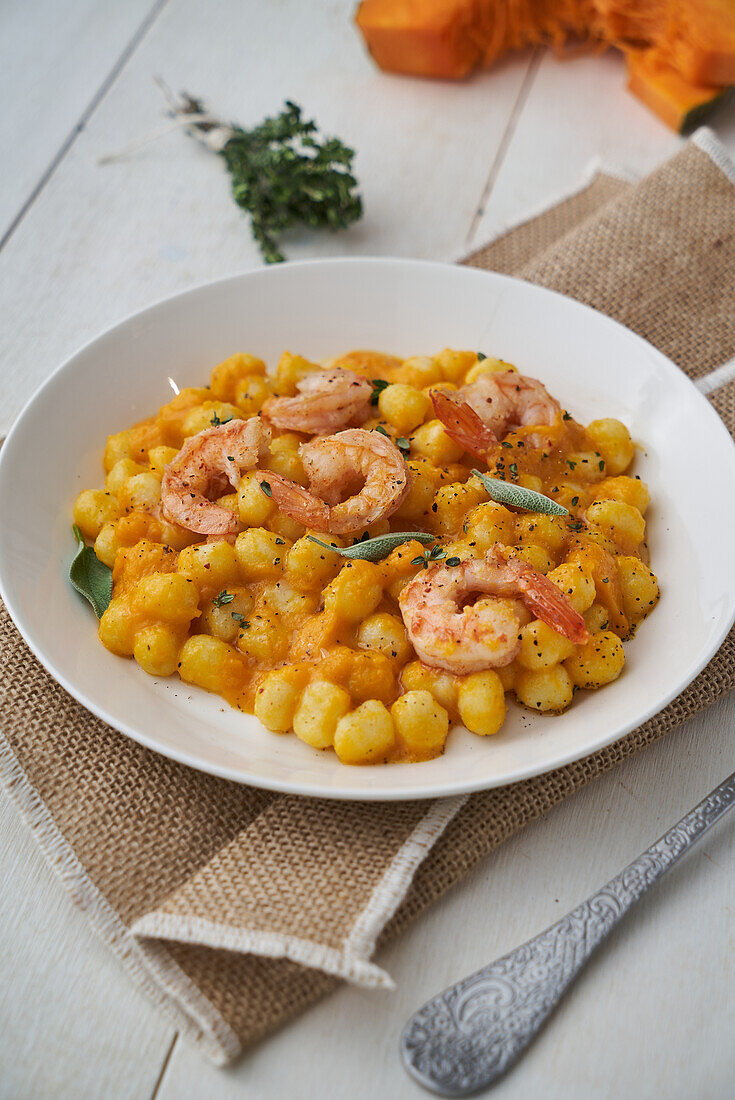 Chicche with pumpkin cream and prawns