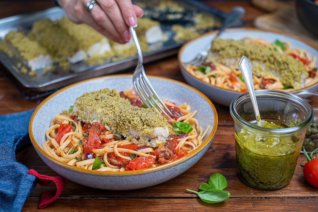 Tomato pasta and fish fillet with herb crust