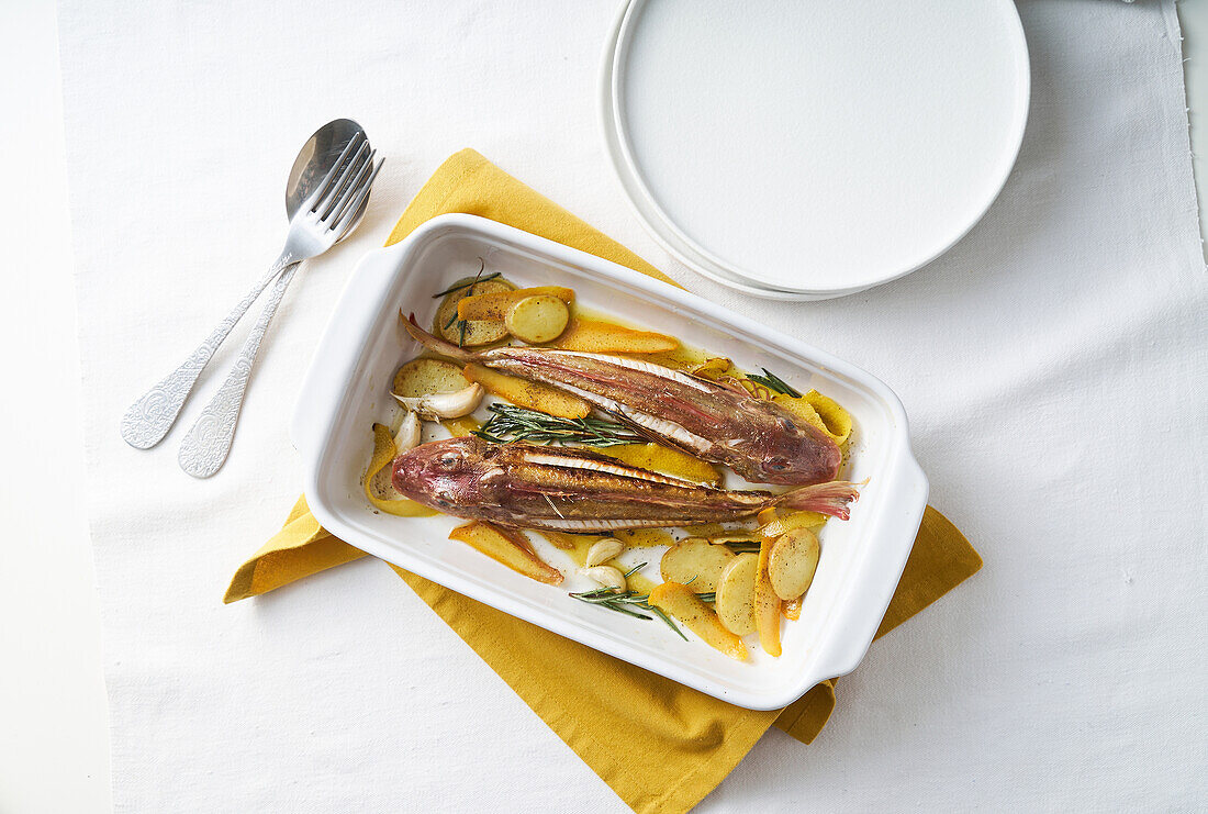 Baked gurnard with potatoes and oranges