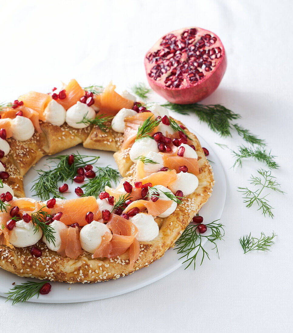 Puff pastry wreath with smoked salmon, cream cheese, dill and pomegranate