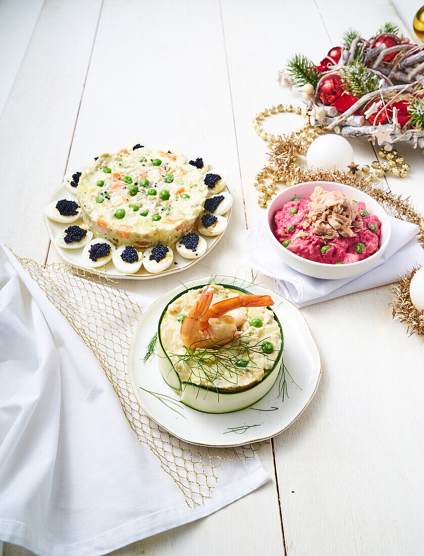 Russian salad with quail eggs, tuna with beetroot and prawns with courgette