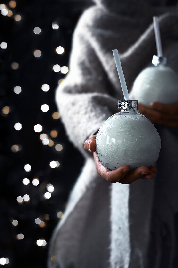 Festive milk drink served in glass Christmas tree baubles