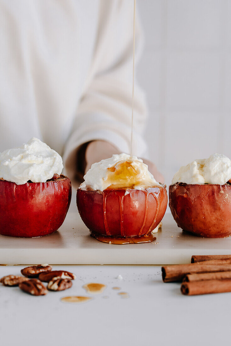 Bratäpfel mit Nussfüllung, garniert mit Sahne und Ahornsirup