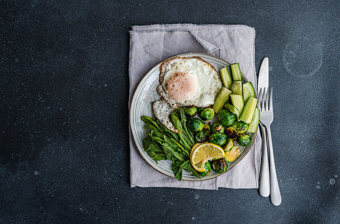 Fried egg with grilled Brussels sprouts and vegetables