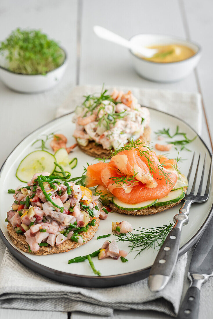 Three kinds of bread with smoked salmon, matjes tartare and crab salad